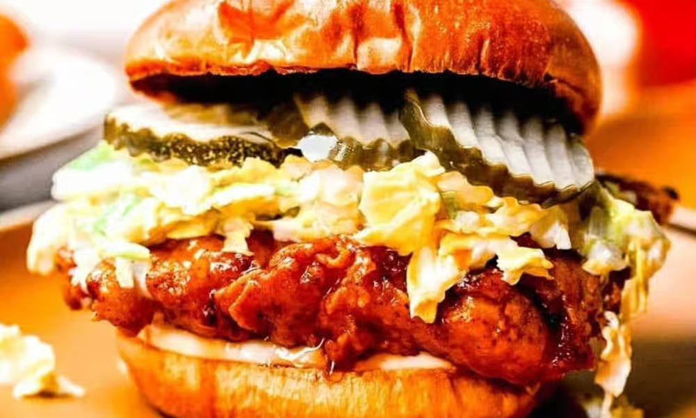 Spicy chicken sandwich with fries from Nour's Cuisine